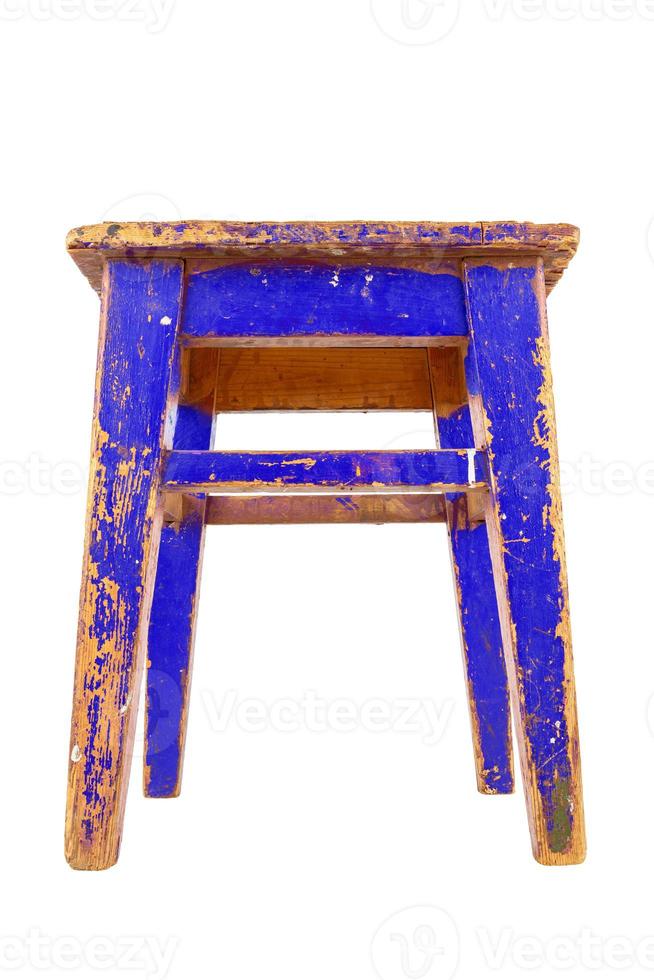 Old blue wooden stool with peeling paint. Loft style chair isolated on a white background. photo