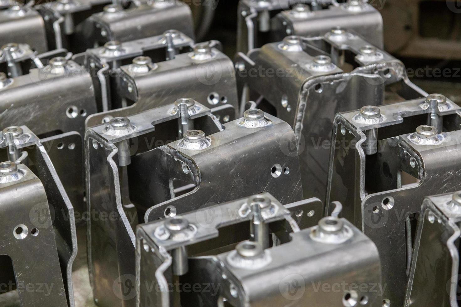 many equal welded aluminium assemblies in factory between operations photo