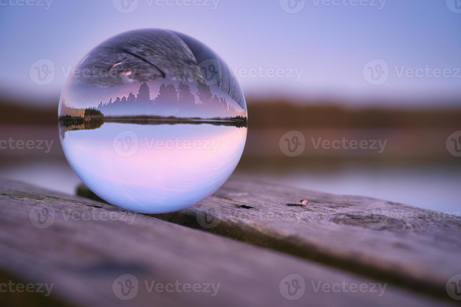 Glass ball on a wooden pier at a Swedish lake at evening hour. Nature Scandinavia photo