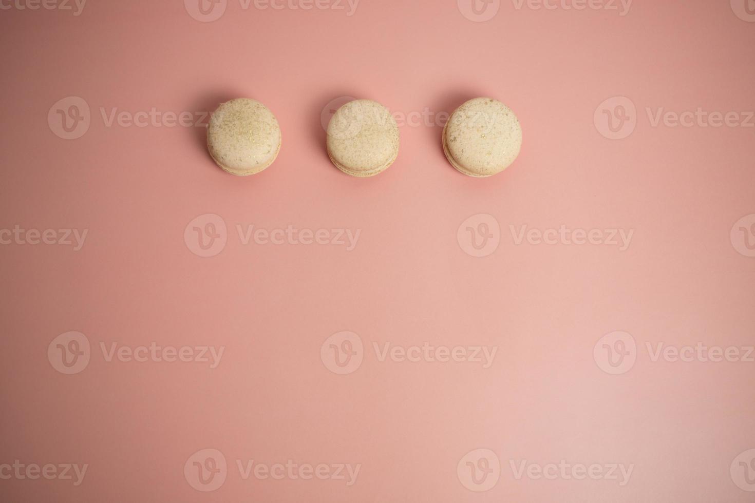 Round beautiful sweets macaroni on a pink background. Still life with macaroni cakes and different flower. Copy space. Banner photo