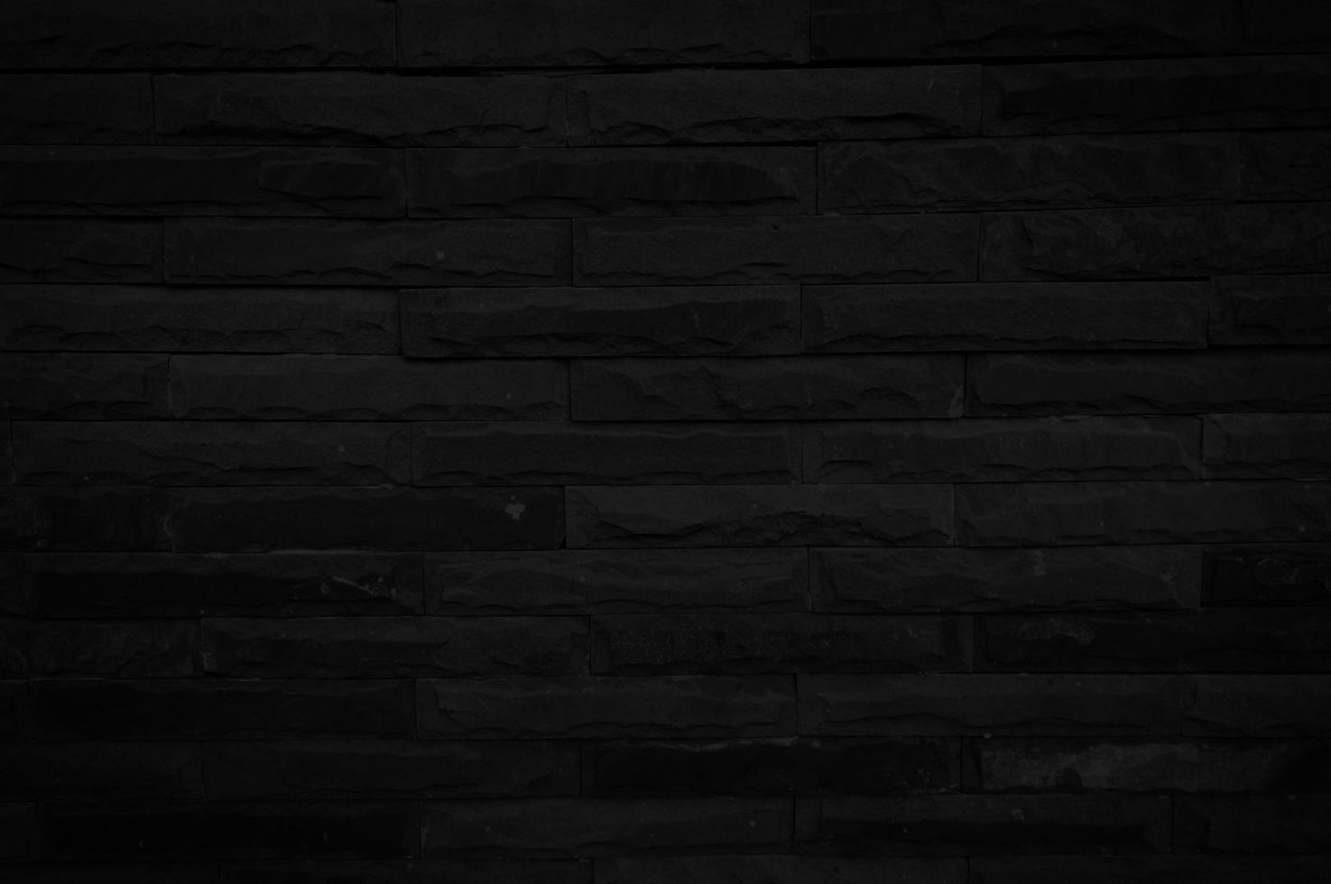 Old black brick wall texture for background with copy space for design. dark wallpaper photo