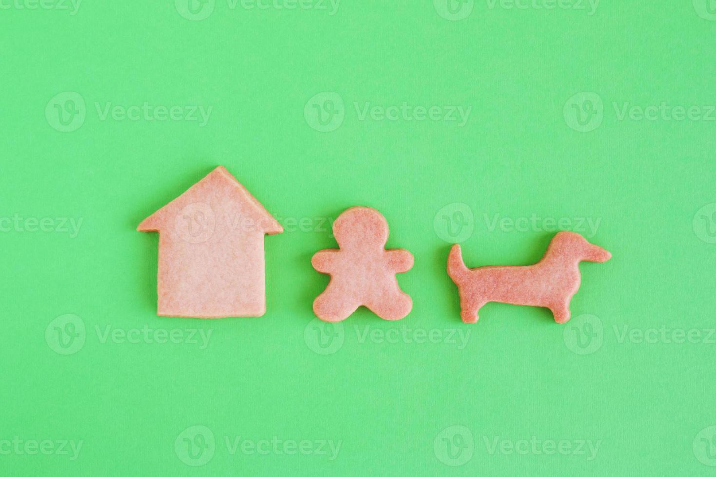 Homemade shortbread cookies on green background, top view. Man is walking with dog near house. photo