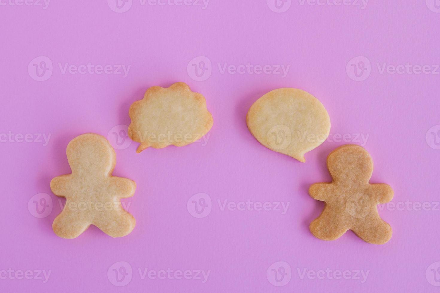 Homemade shortbread cookies on pink background, top view. Two people with callout bubble blank message. photo