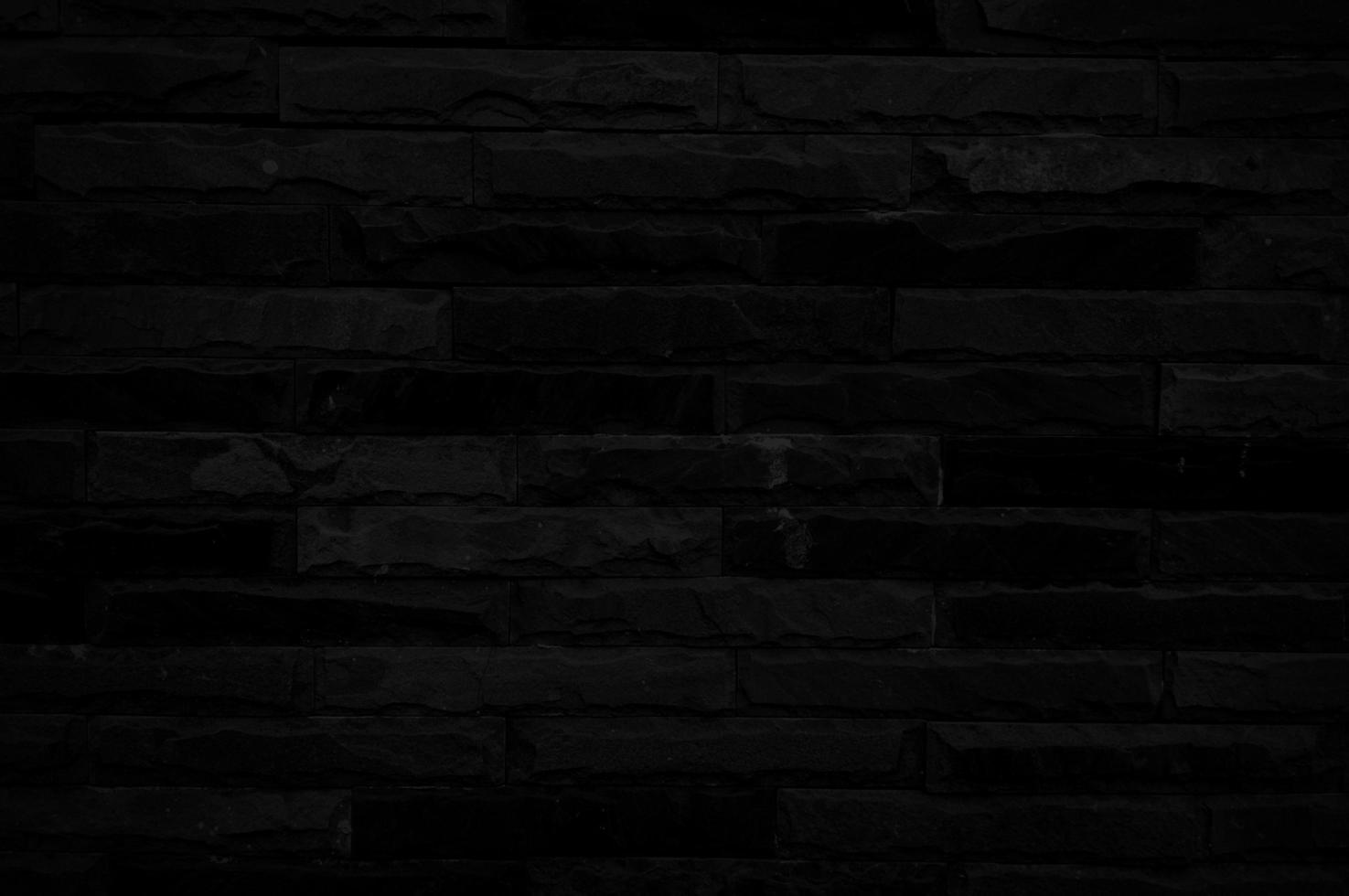 Old black brick wall texture for background with copy space for design. dark wallpaper photo