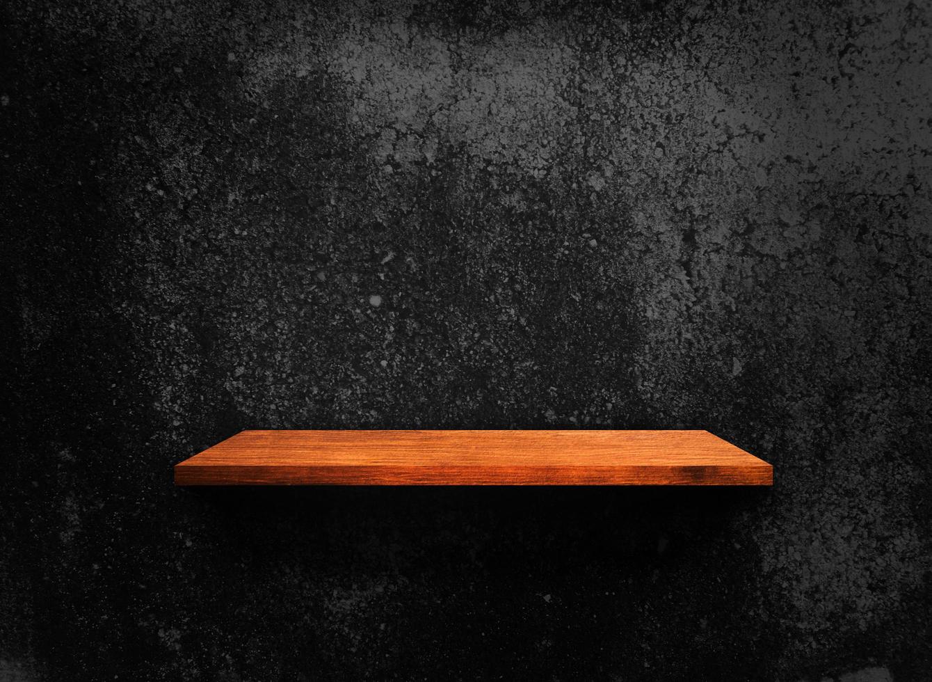 Blank of old wooden shelf on dark wall texture background with clipping path for design photo