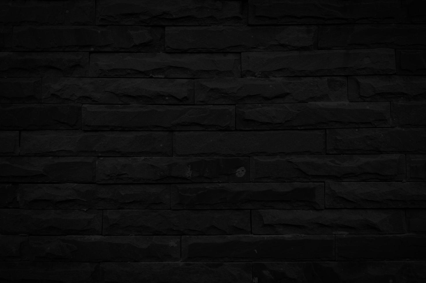 Old black brick wall texture for background with copy space for design. dark wallpaper photo