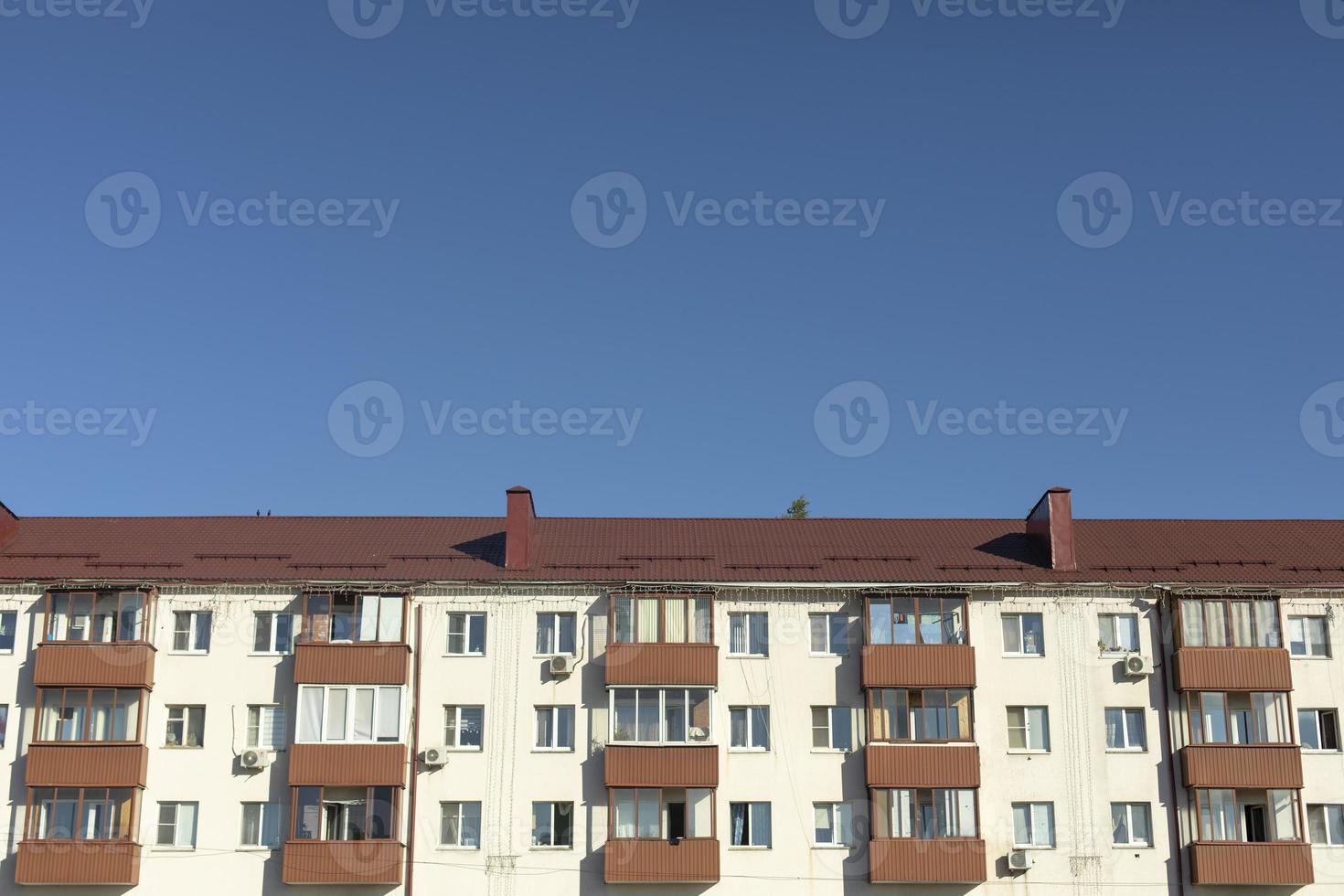 Building in city. House with apartments. Facade of residential building. photo