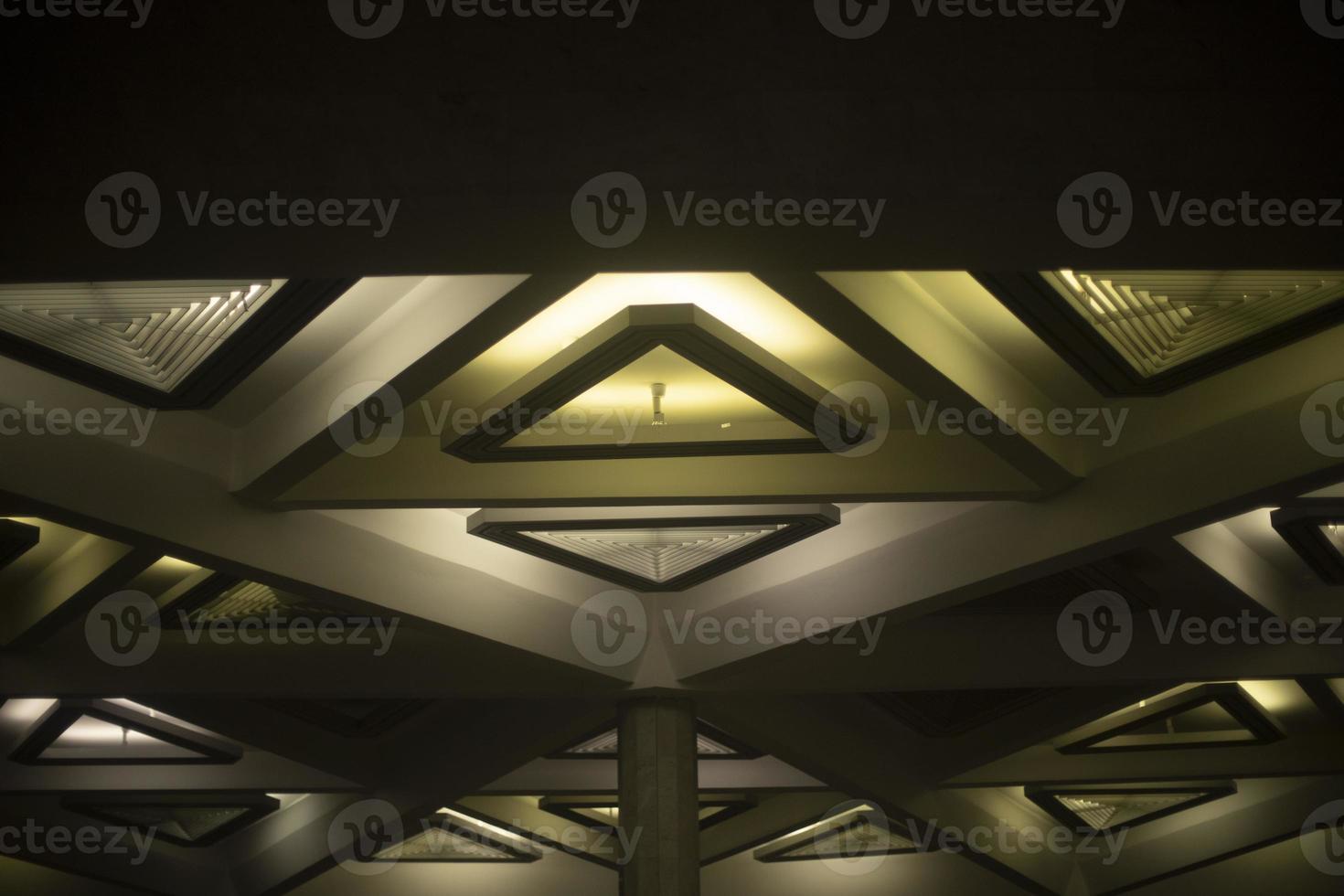 Light triangle. Lamp on ceiling. Light design. Architecture of 20th century. photo