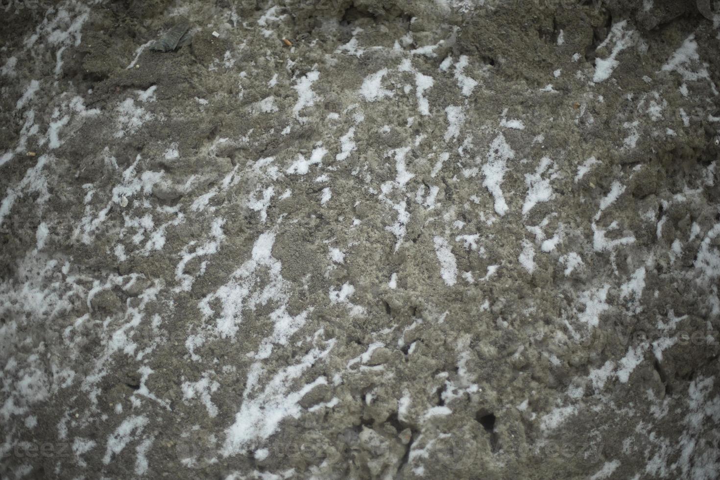 Texture is dirty snow. Snow on side of road. Pollution in city is in detail. photo