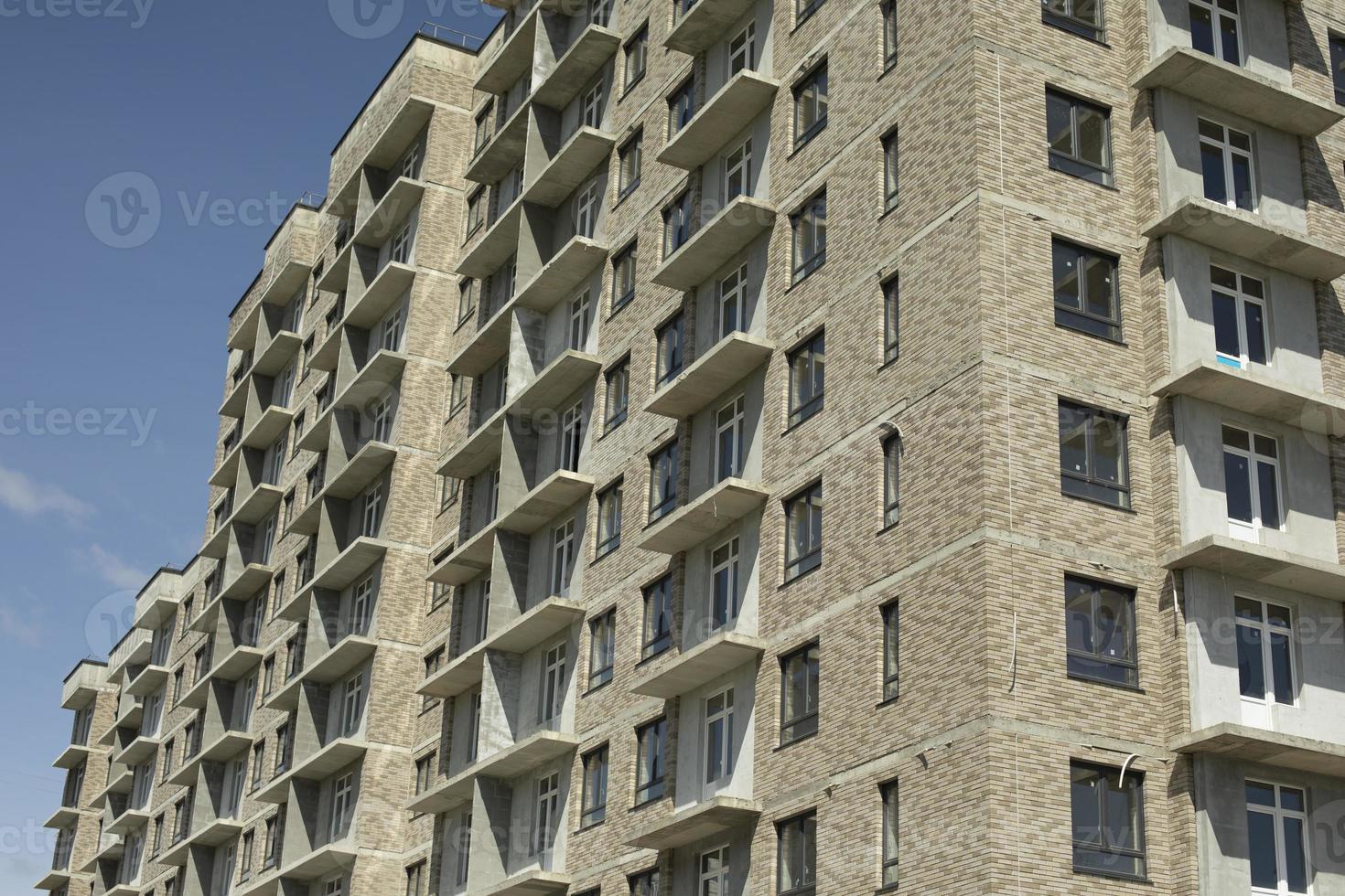 Building in city. Architecture details. Lots of windows in house. photo