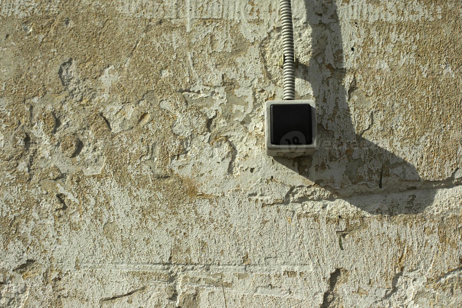 Wall switch. Button for light. Wire to button. Wall with switch. photo