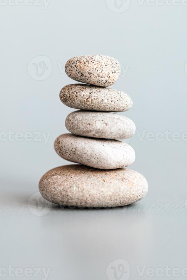 Stones stacked in pyramid, balance, stability, zen, meditation, body mind and soul harmony concept photo