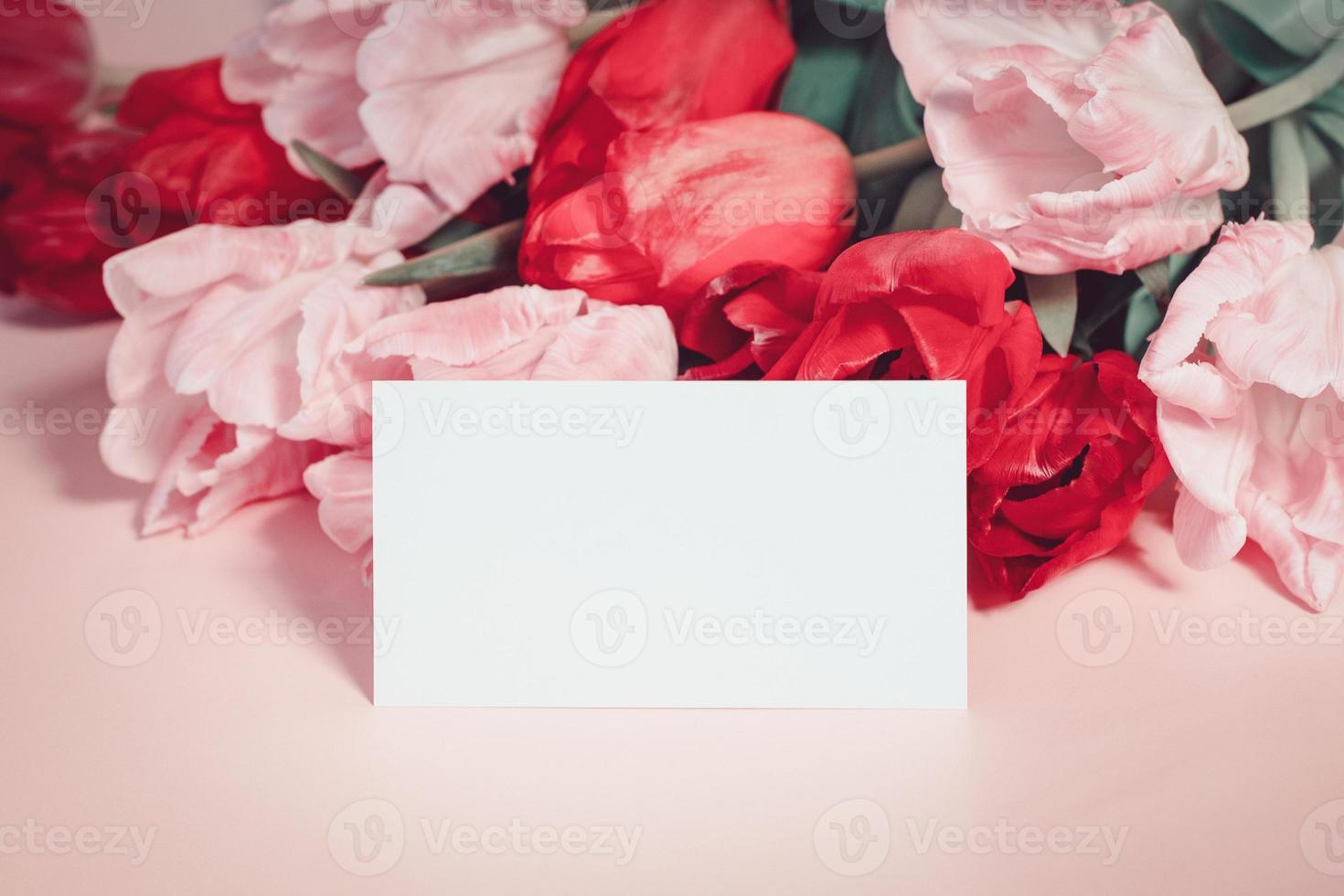 Flowers and paper card mockup, pink tulips with place for text photo