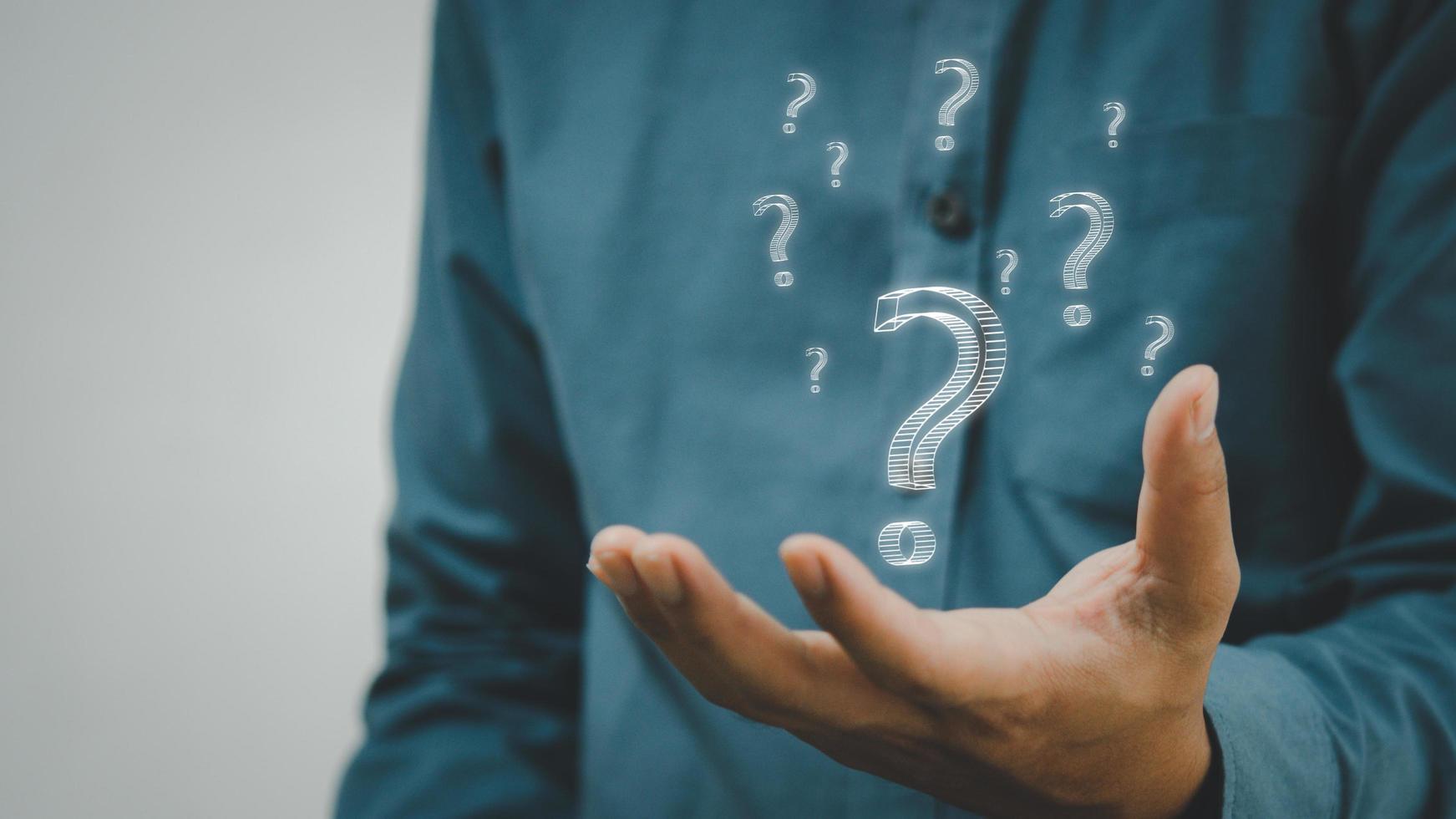 business man icon questions marks on virtual screen at interrogation. photo