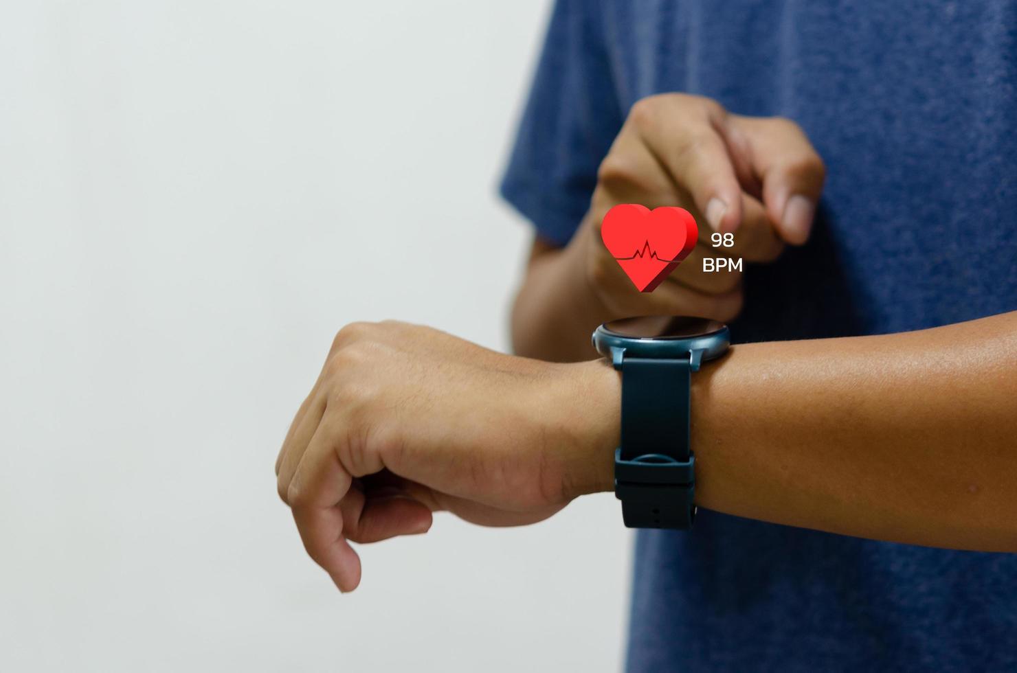 man using smart watch with icon heart red health care concept. photo