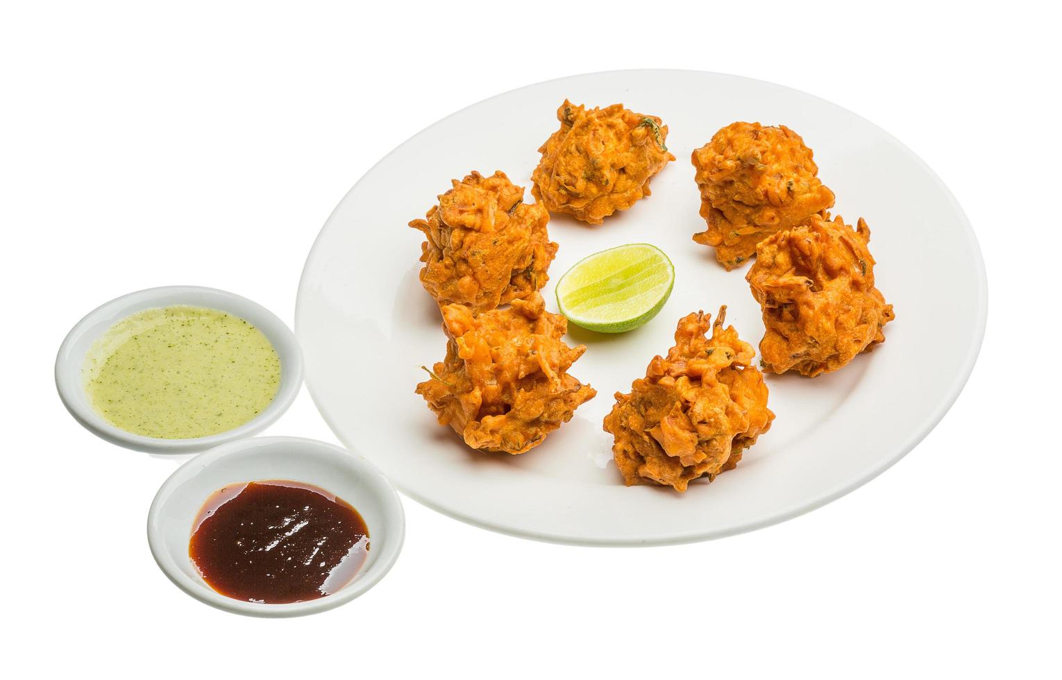 Onion bhajee on the plate and white background photo