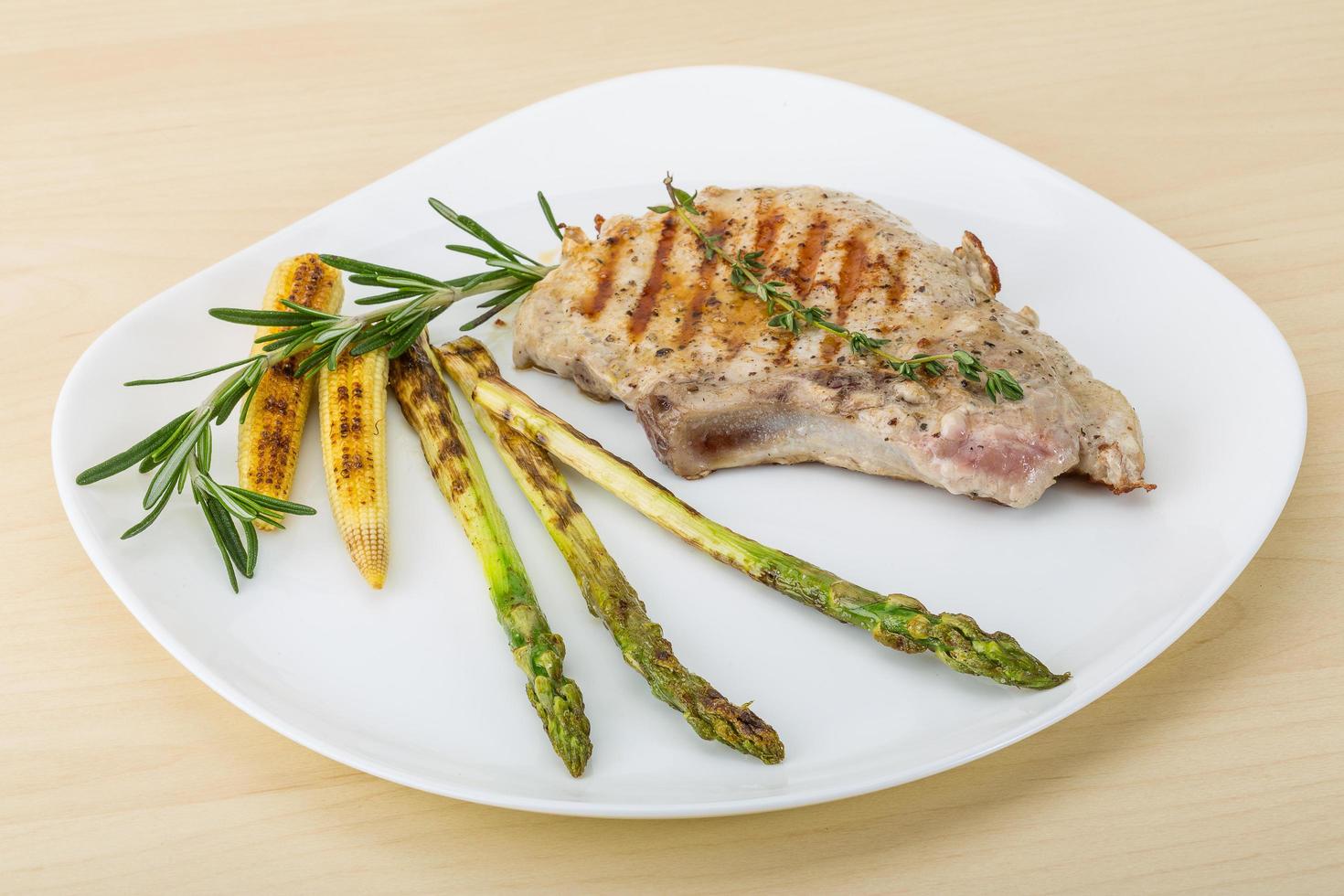 Pork steak on the plate and wooden background 12685060 Stock Photo at