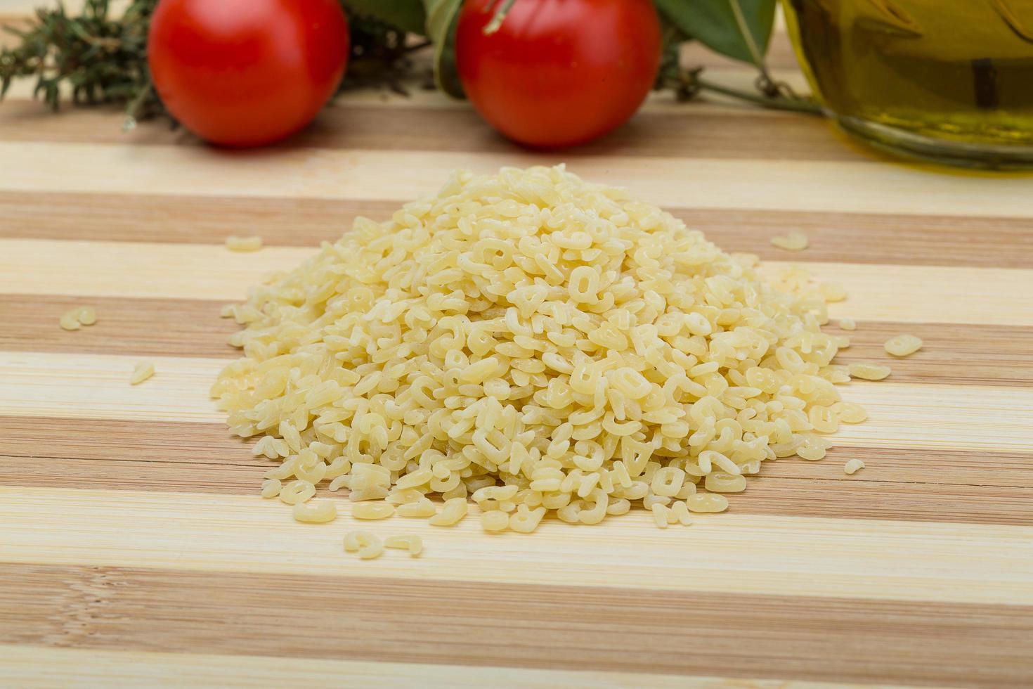 ABC macaroni on wooden board and wooden background photo