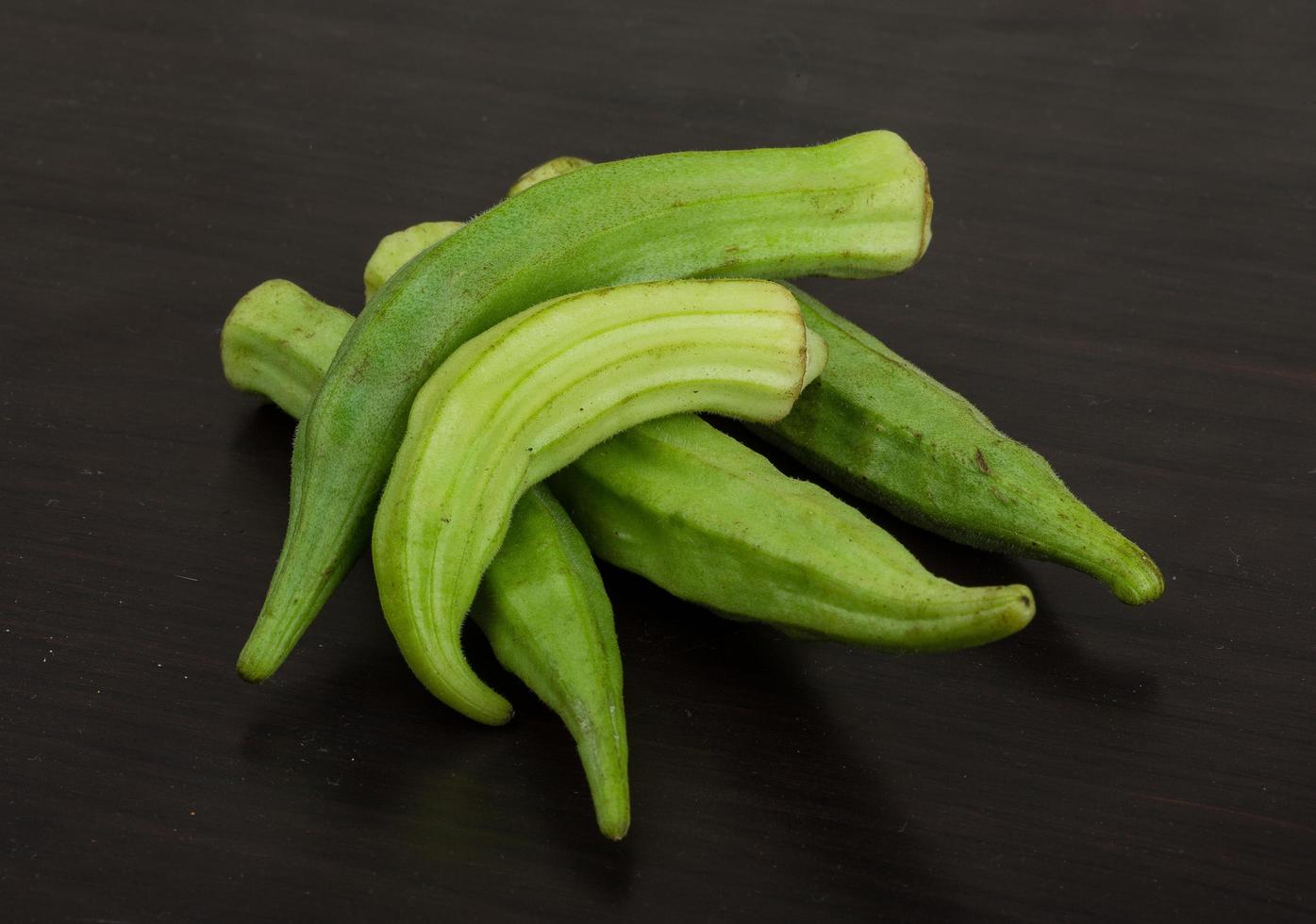 Okra vegetables on wooden background photo