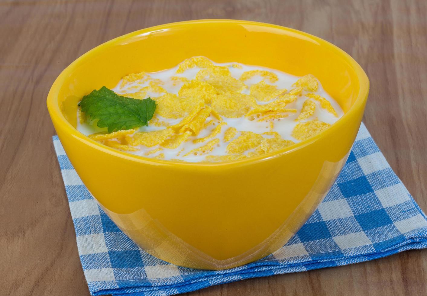 Cornflakes in a bowl on wooden background photo