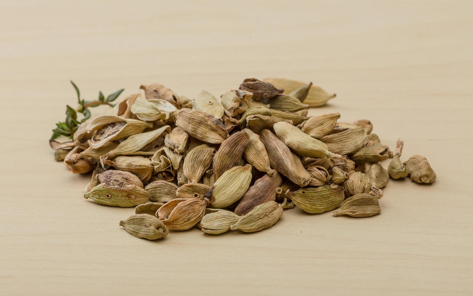 Cardamom on wooden background photo