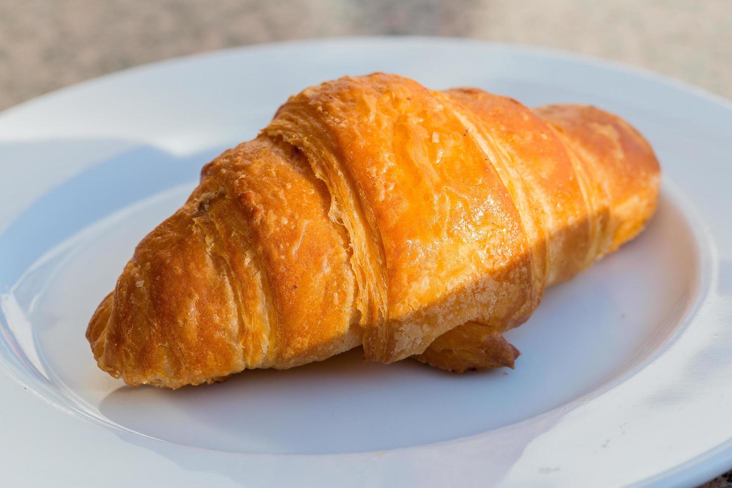 Croissant on the plate photo