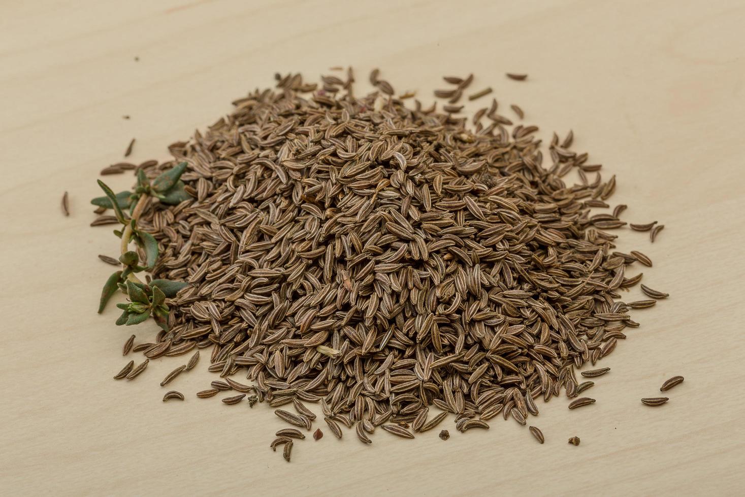Dry caraway on wooden background photo