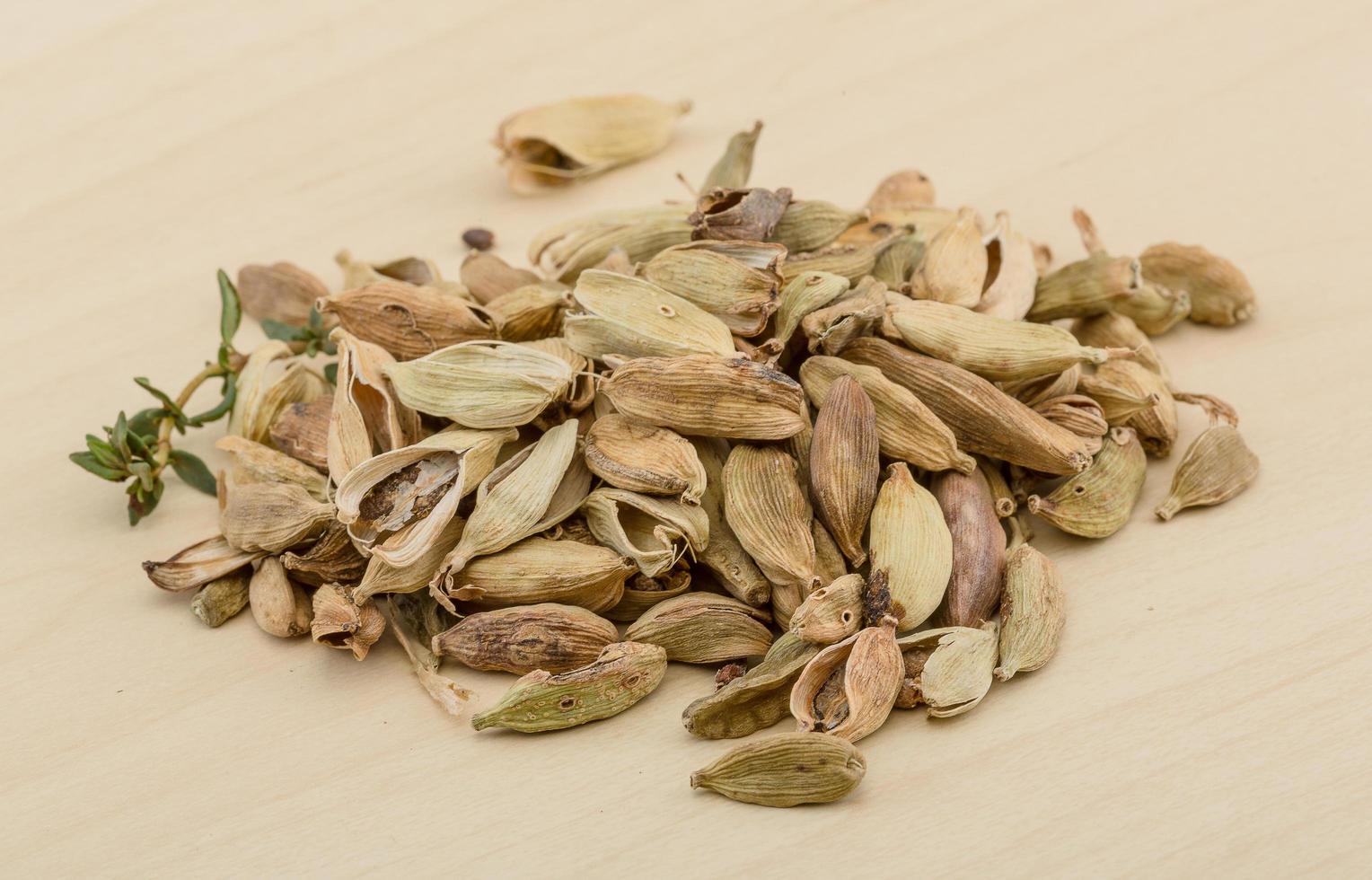 Cardamom on wooden background photo