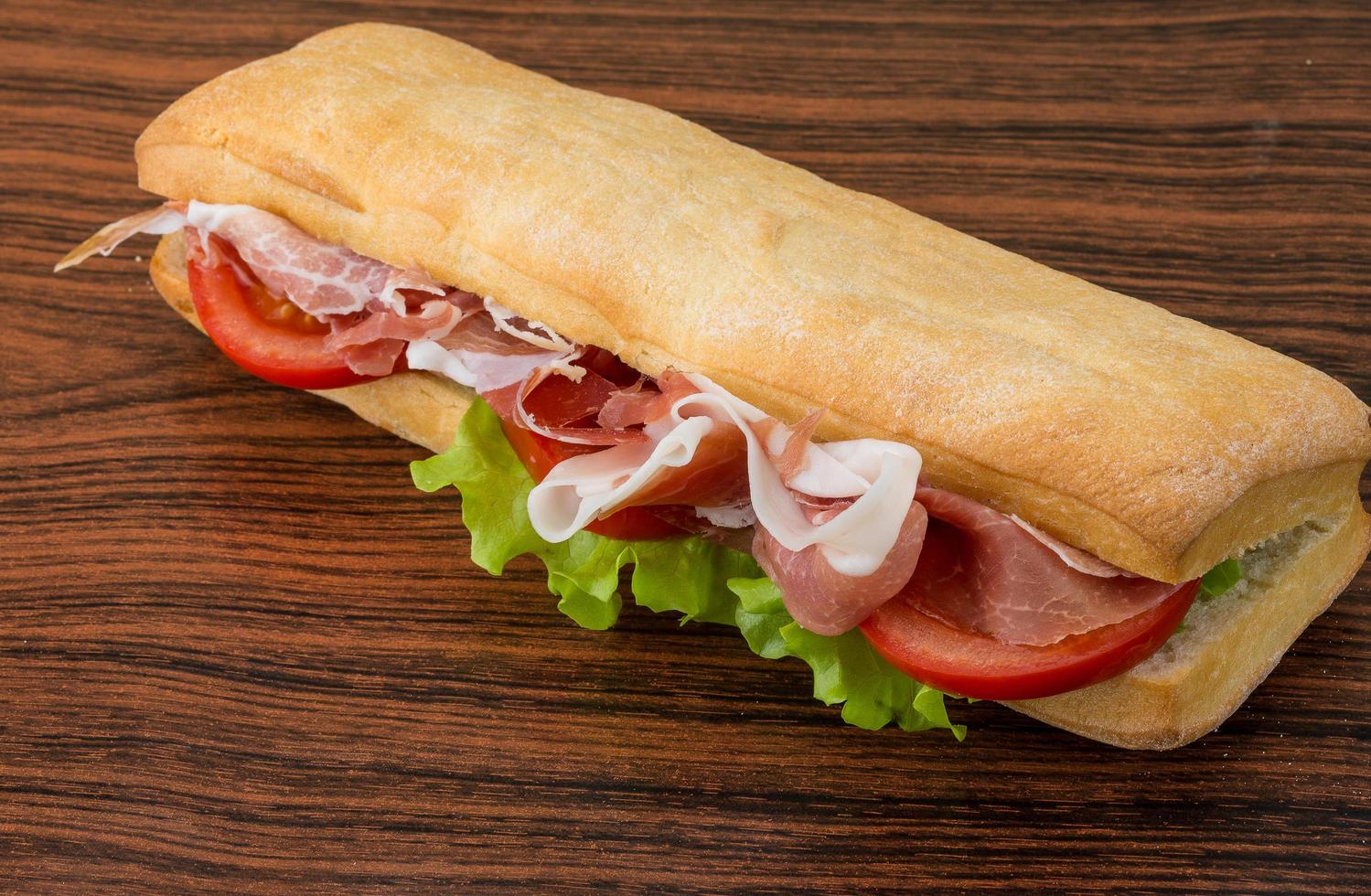 Ham sandwich on wooden background photo