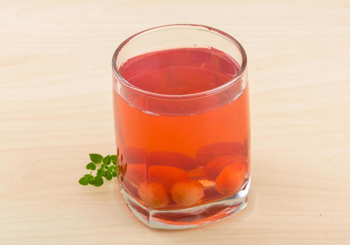 Cornel compote on wooden background photo