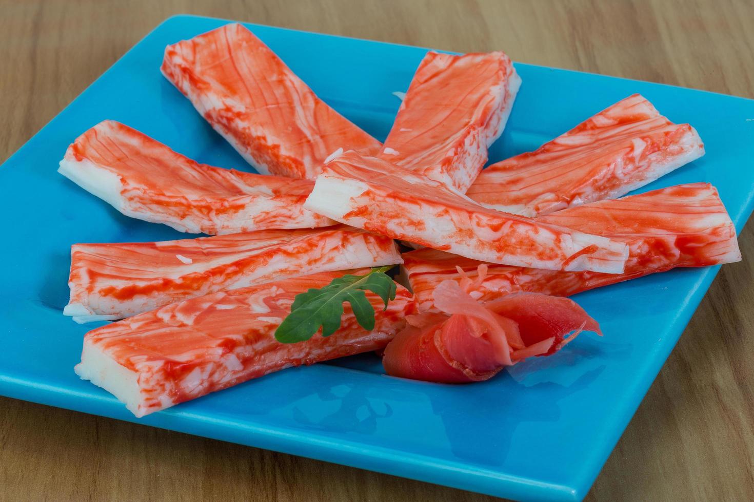 Crab sticks on the plate and wooden background photo