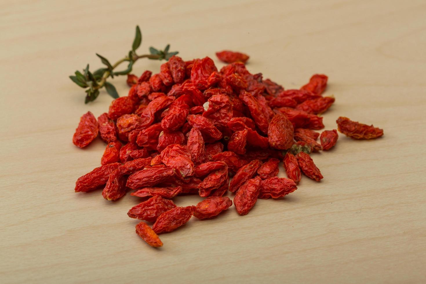 Goji berry on wooden background photo