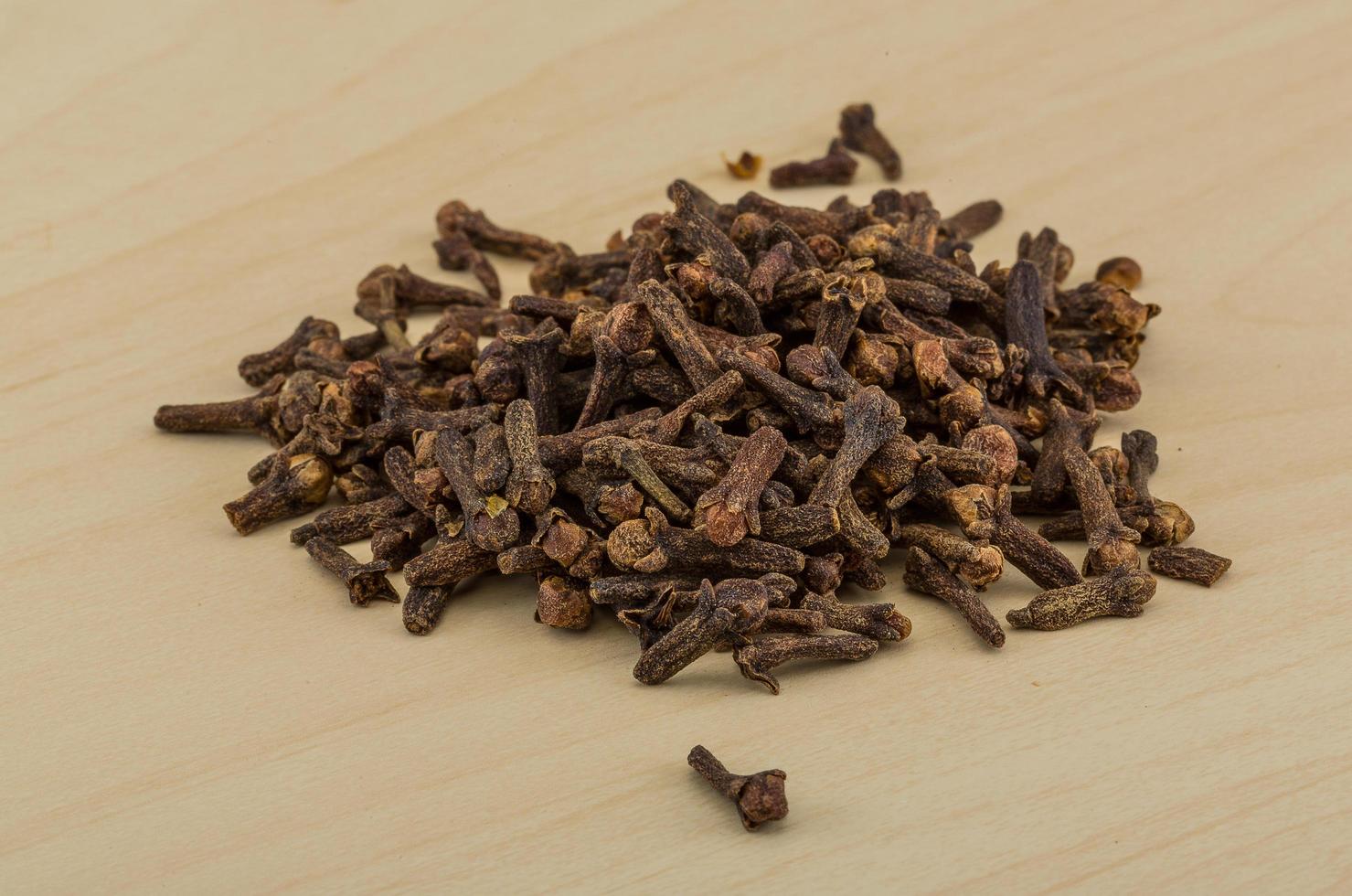 Clove seeds on wooden background photo