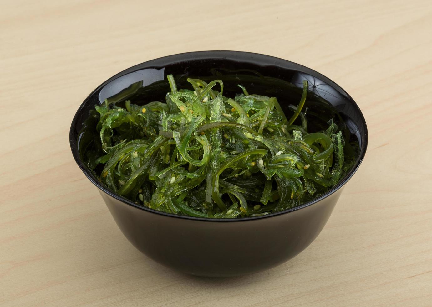 Chuka salad in a bowl on wooden background photo