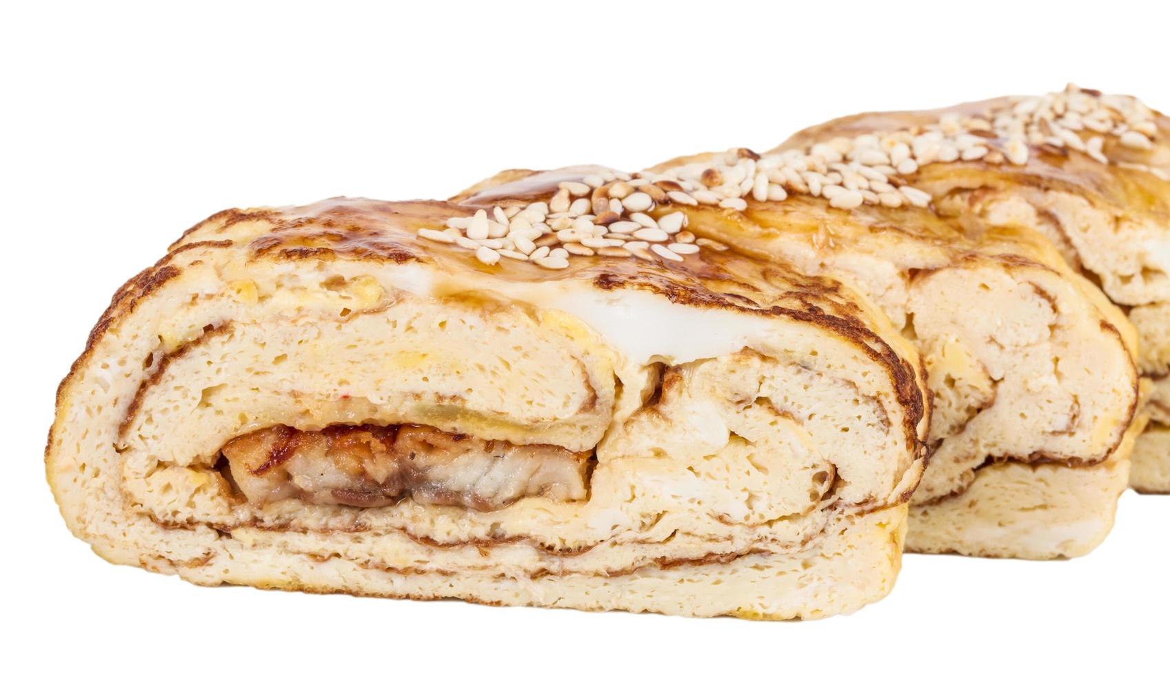 Omelet Maki Sushi - Roll made of Smoked Eel inside. Topped with Japanese Omelet and Sauce photo