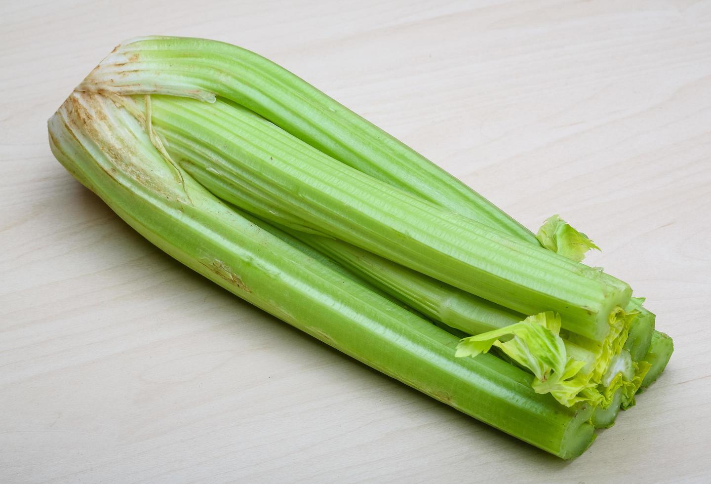 Celery on wooden background photo