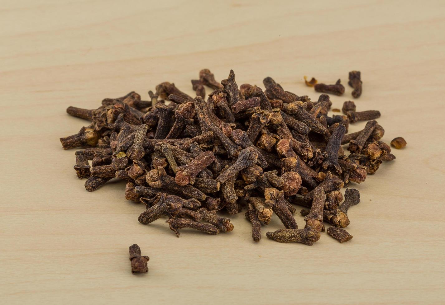 Clove seeds on wooden background photo