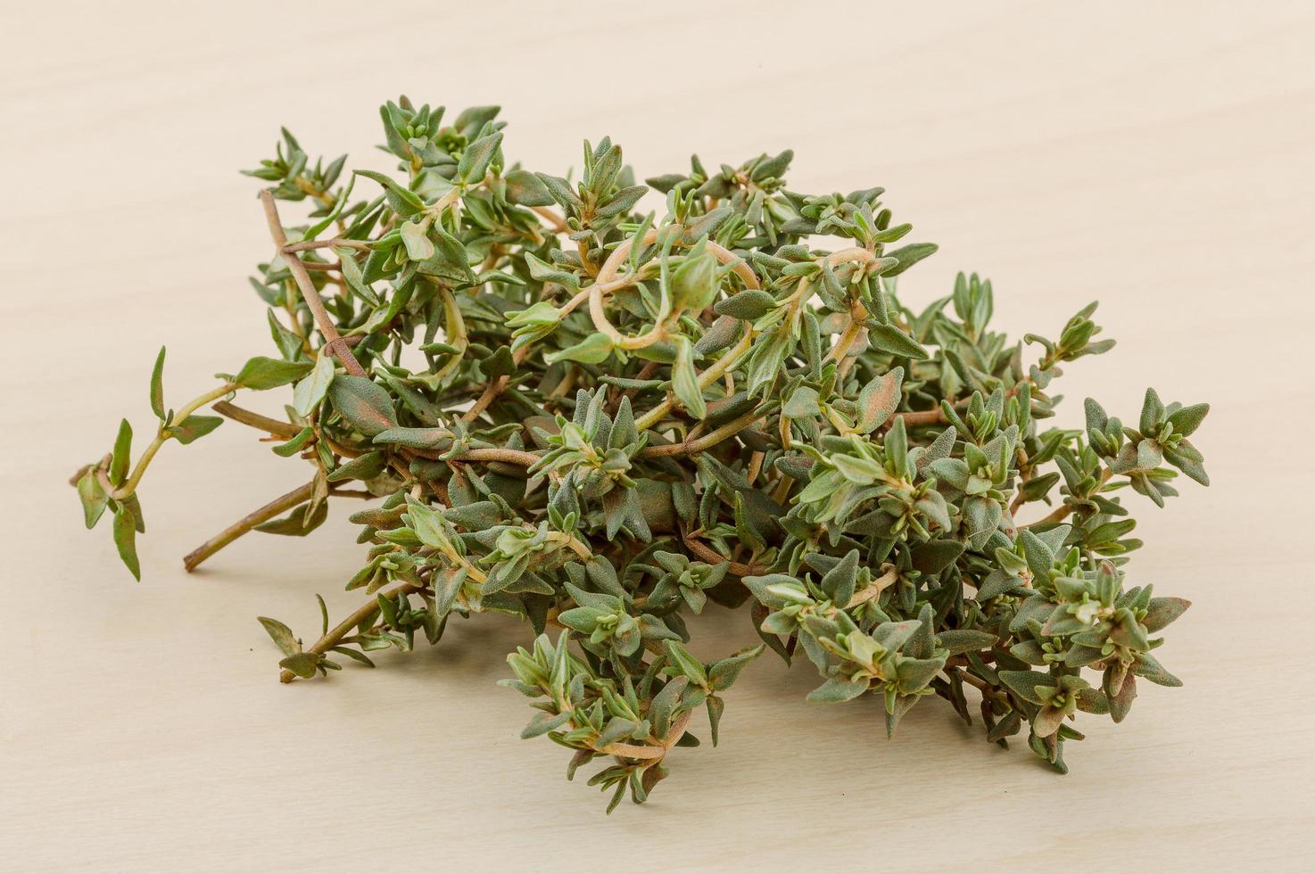 Thyme on wooden background photo