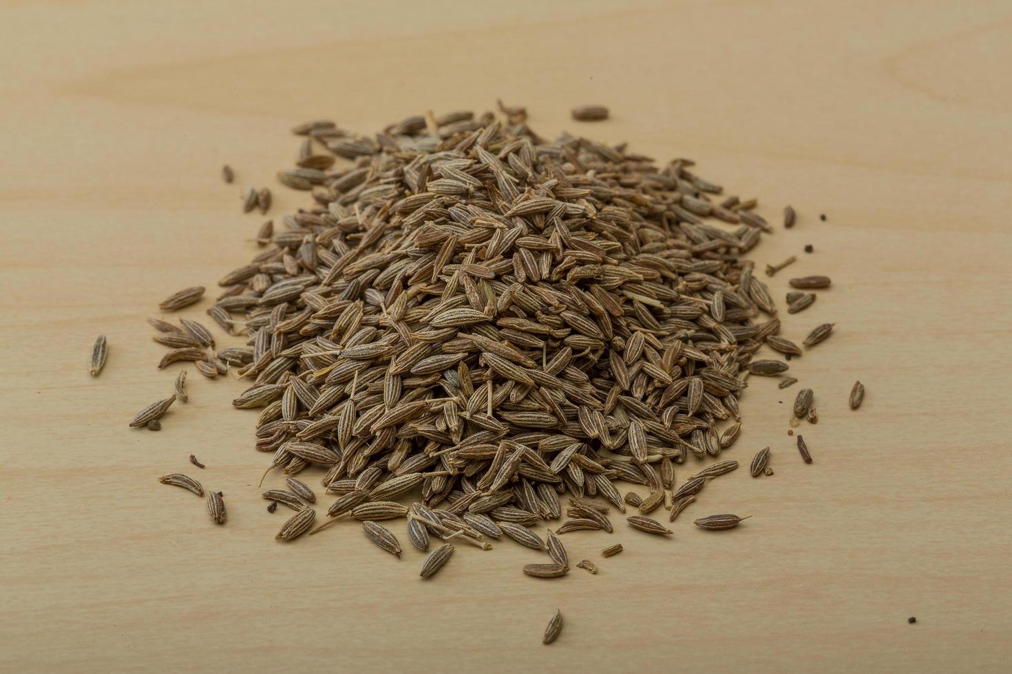 Zira seeds on wooden background photo