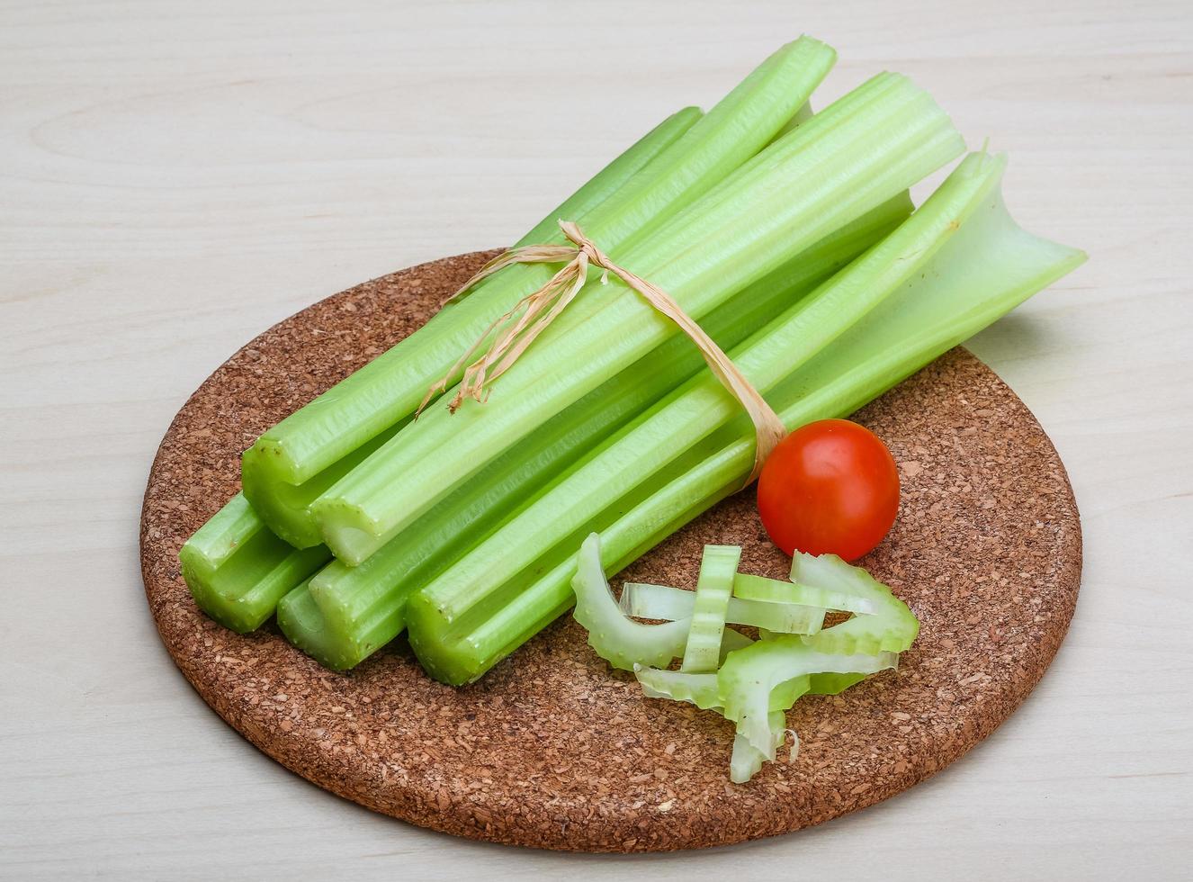 Celery on wooden board and wooden background photo