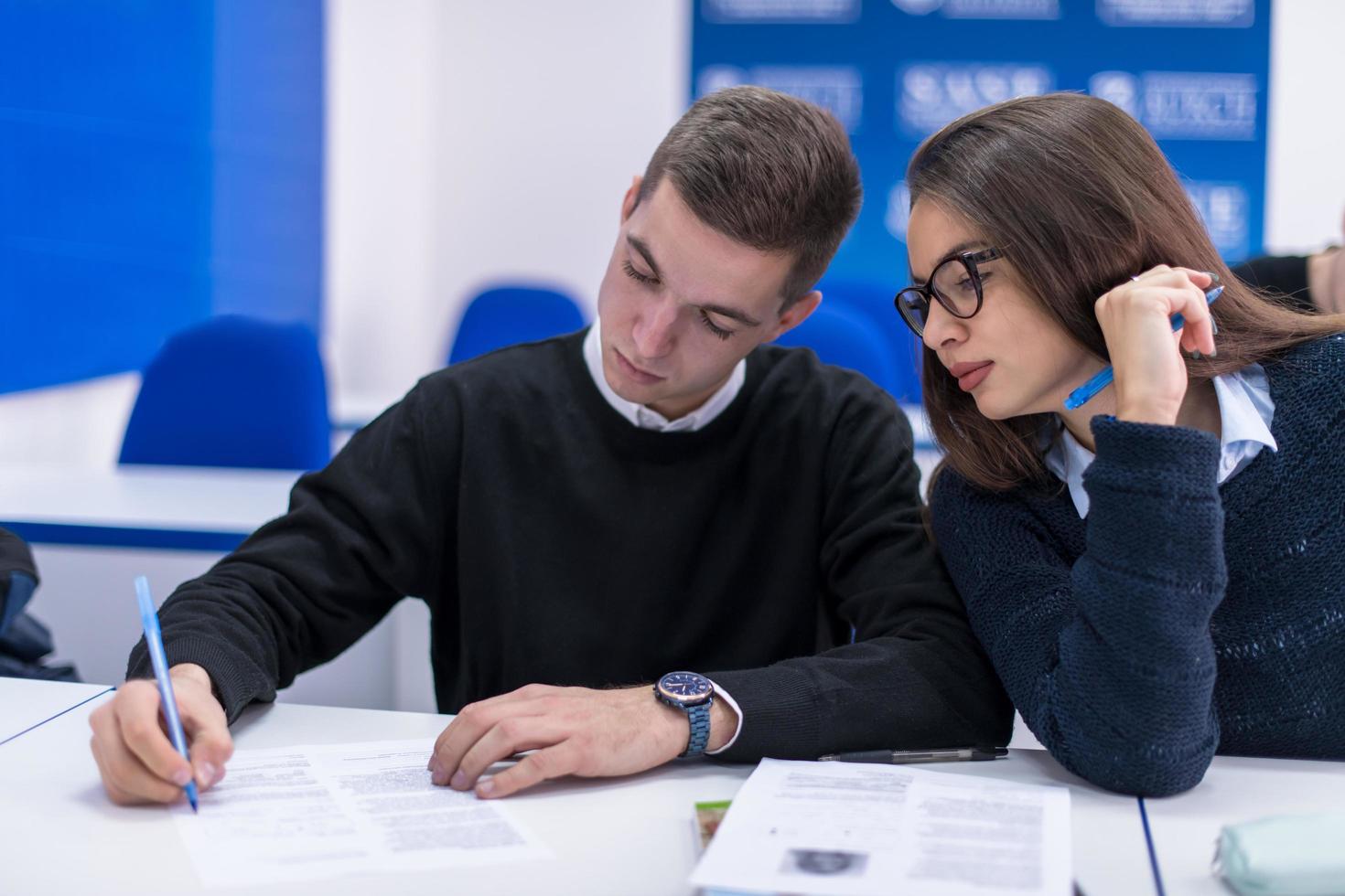 young students writing notes photo