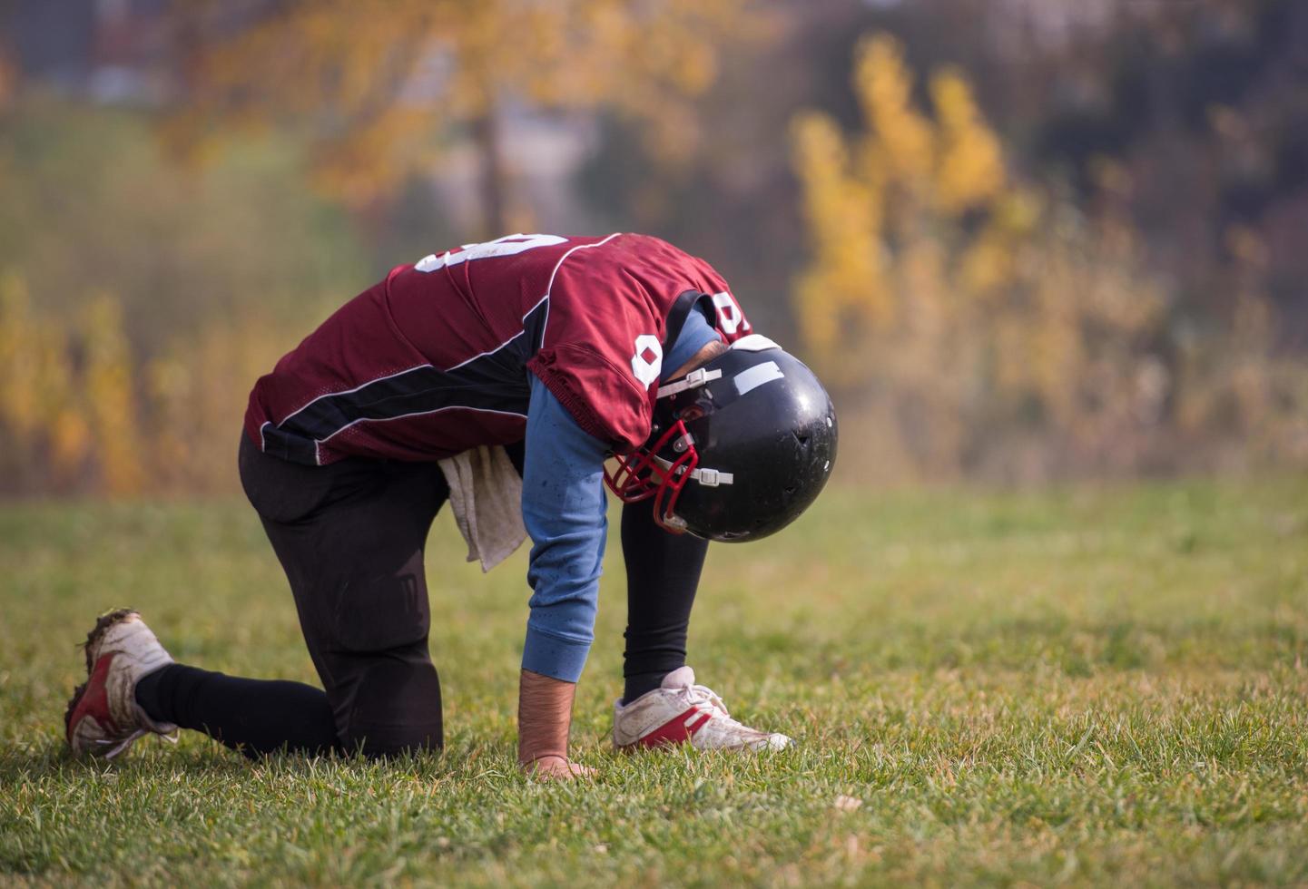 american football player resting after hard training photo