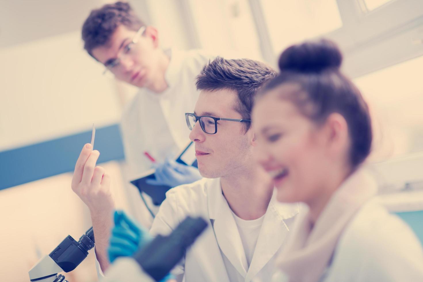 Group of young medical students doing research photo