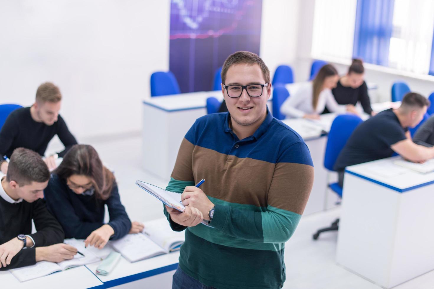 male student with others writing notes photo