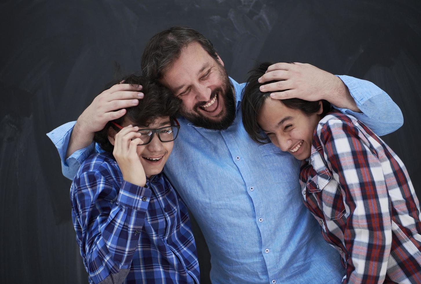 happy father hugging sons photo