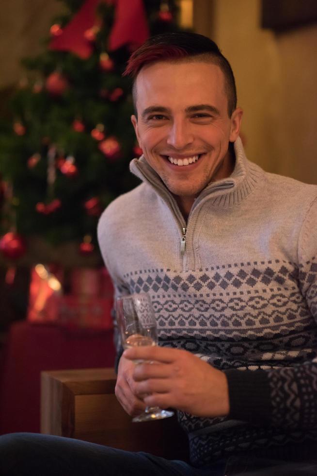 Happy young man with a glass of champagne photo