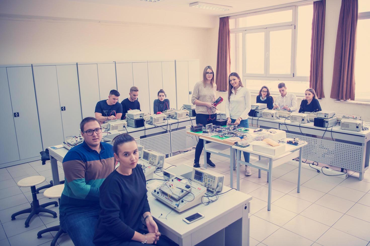 students doing practice in the electronic classroom photo