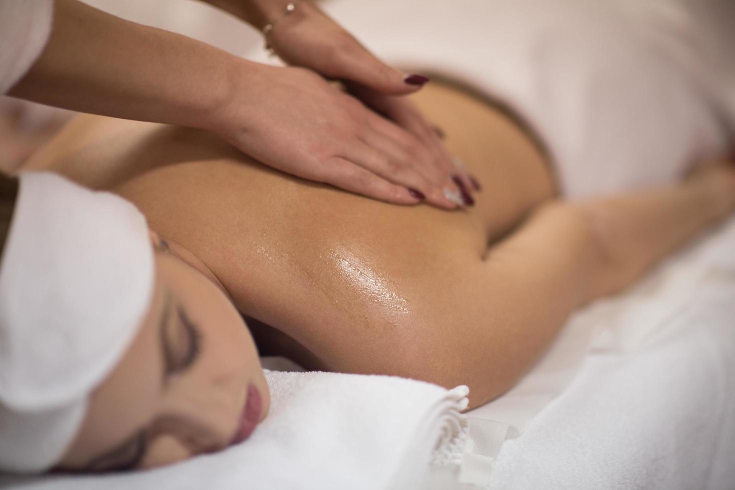 woman receiving a back massage photo