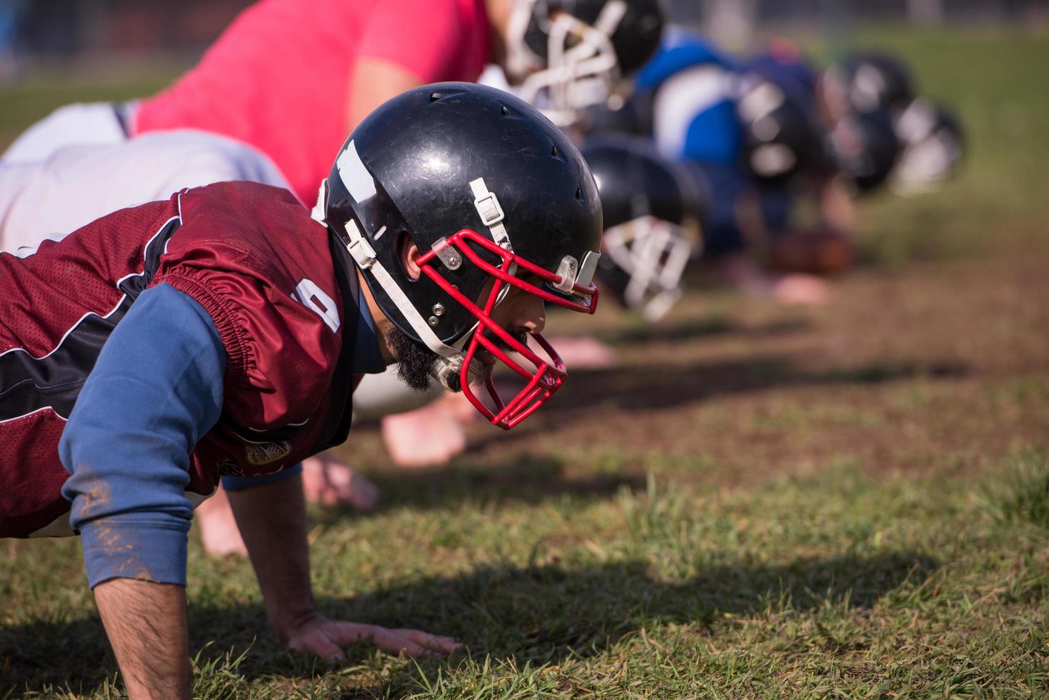 american football team doing push ups photo