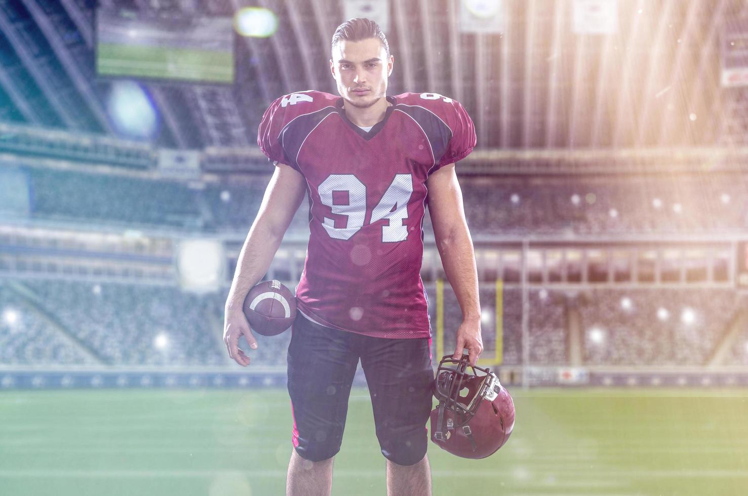 American Football Player isolated on big modern stadium field photo